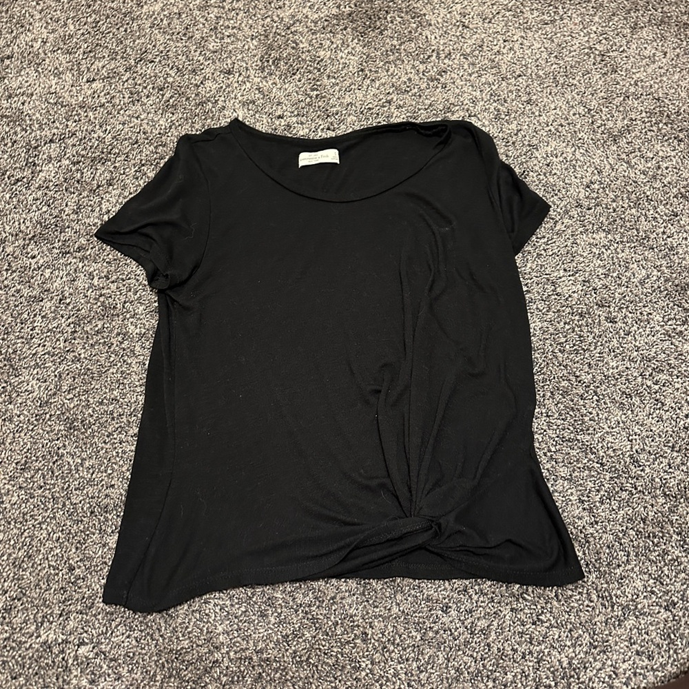 Basic black top, light and good for work, tie in front to give it something